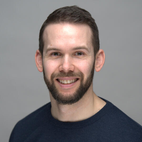 Headshot A headshot picture of Evan Poncelet, evaluation consultant.